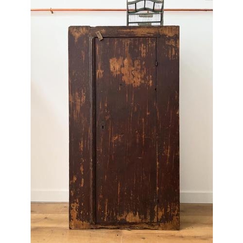 A perfectly rustic 19th century Irish cupboard. In its original warm, reddy brown paint. with excellent dimensions for...