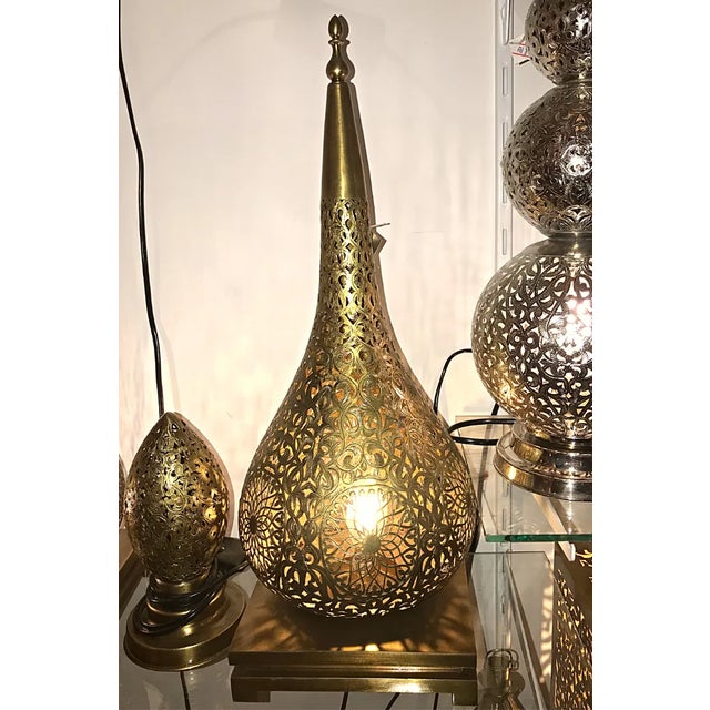 This stunning brass floor lamp was expertly crafted in Marrakech, known for its rich cultural history and skilled...