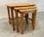 Vintage 1960s maple and oak wood nesting tables. The table tops have a rounded edge and all sit neatly within each other....