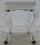A modern era rolling stool on acrylic legs. The stool offers a white upholstered square seat set on ‘S’ shape acrylic legs...