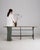This piece presents as a bench/table, distinguished by black wrought iron base, natural wood top. Dating to 1900s and...