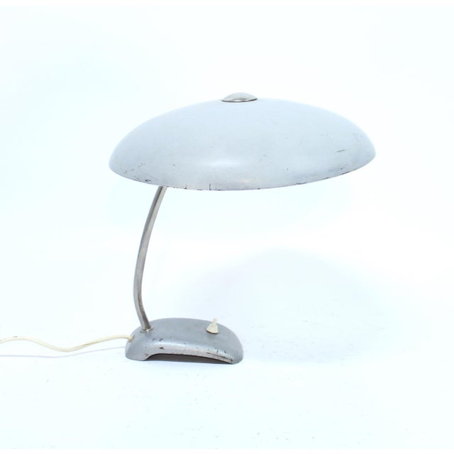 Industrial table lamp from the 1930s with round sheet metal shade one a chromed stem mounted to a metal base. Attributed...