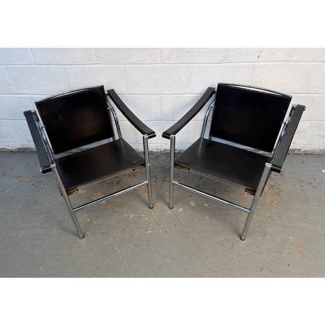 Iconic and timeless, these vintage LC1 Basculant sling chairs exemplify the modernist vision of Le Corbusier, Pierre...