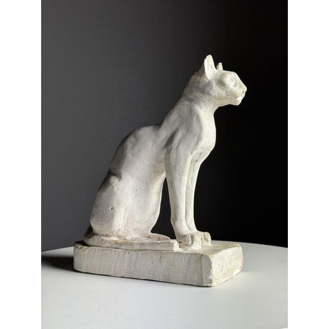Plaster statue of cat. Origin from France, 20th century. Dimensions: 33h x 26l x 11.5w