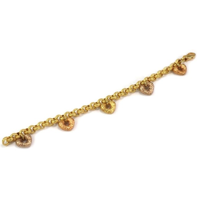 This authentic vintage charm bracelet is beautifully crafted in rich 19k multicolor gold and features five hand-hammered...