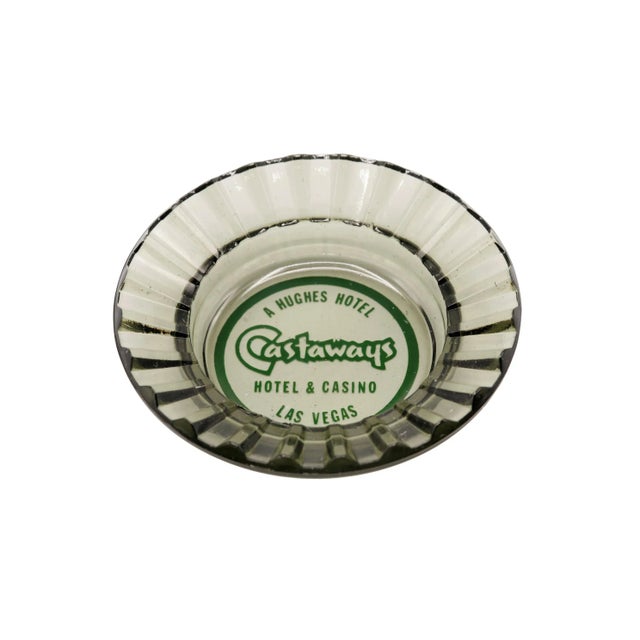 A pair of gray tinted glass ashtrays from The Castaways Hotel, a hotel and casino in Paradise, Las Vegas, Nevada. The...