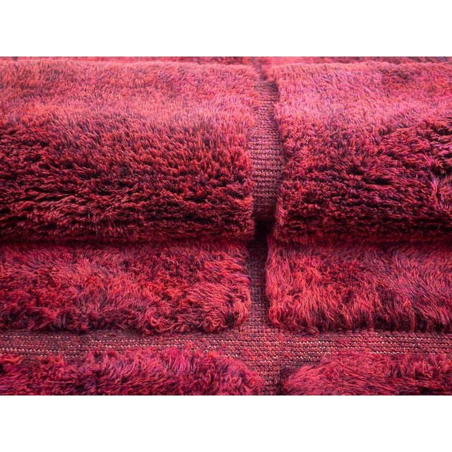 Rich, velvety, and unmistakably luxurious. This hand-knotted Moroccan wool rug features a striking grid of deep, velvet-...