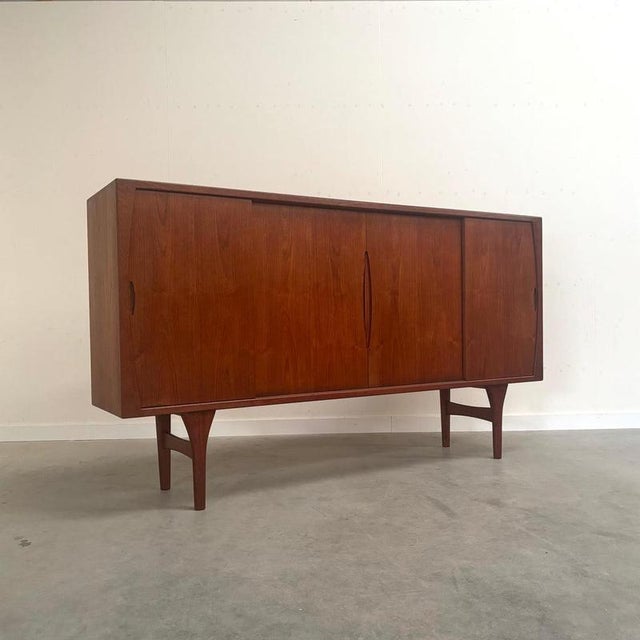 Remarks: Bruno Hansen sideboard / highboard designed by Henning Kjærnulf, Denmark 1960s. Outside teak veneer and inside...