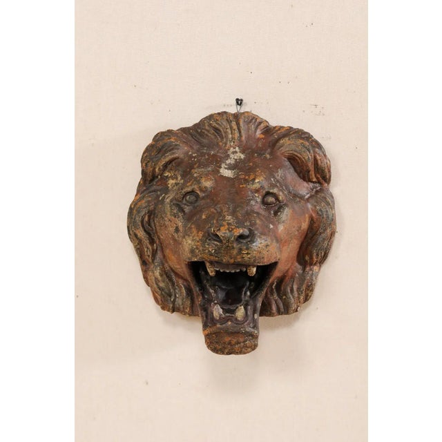 A terracotta lion head wall mounted decoration. This vintage terracotta lion, attributed to have originated out of The...