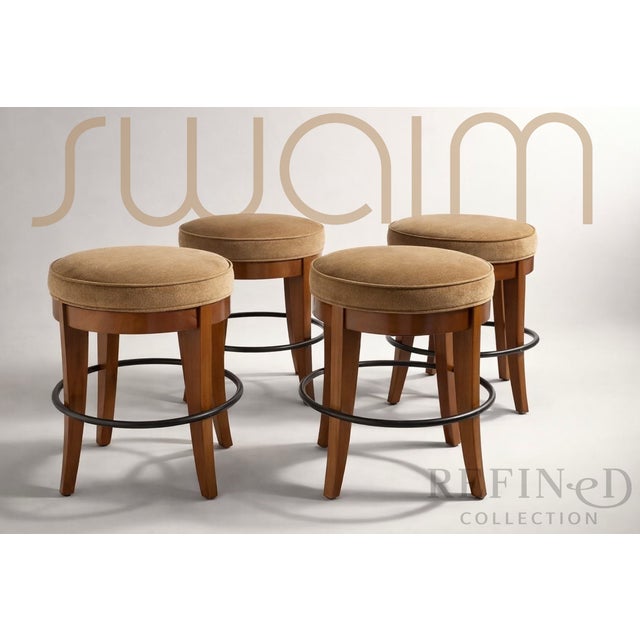 A refined set of four upholstered stools by Swaim, showcasing the brand’s hallmark craftsmanship and understated luxury....