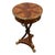 Elegant round pedestal accent table featuring rich wood veneer, a brass gallery edge, and tripod base with brass claw...