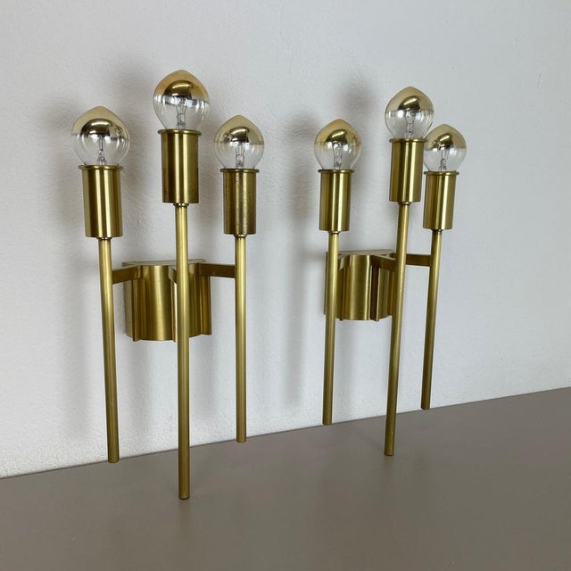 This modernist light set was produced in italy in the 1970s in italy. It is made of brass and features a very unique and...