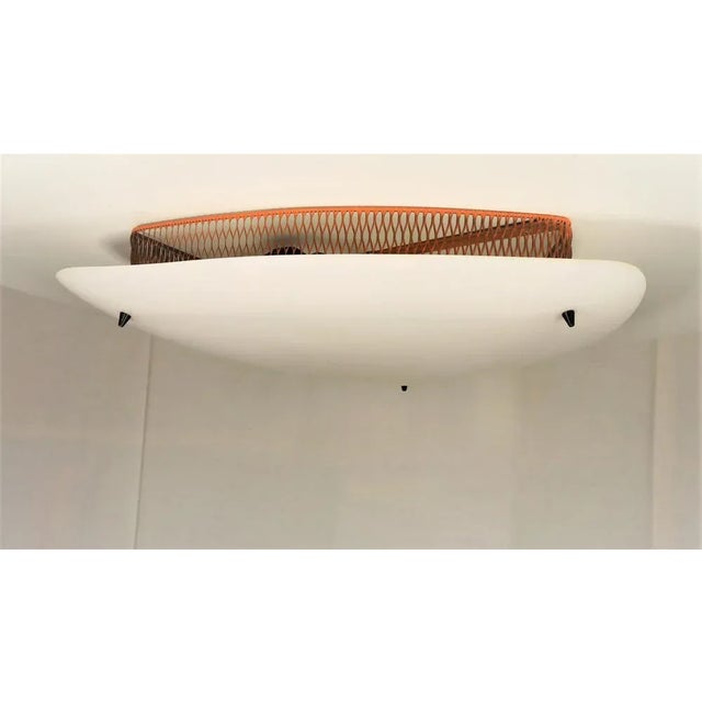Large "kite" ceiling lamp in Matégot 1960 style. Triangular reflector in opaque white acrylic glass. Decor of 3 black...