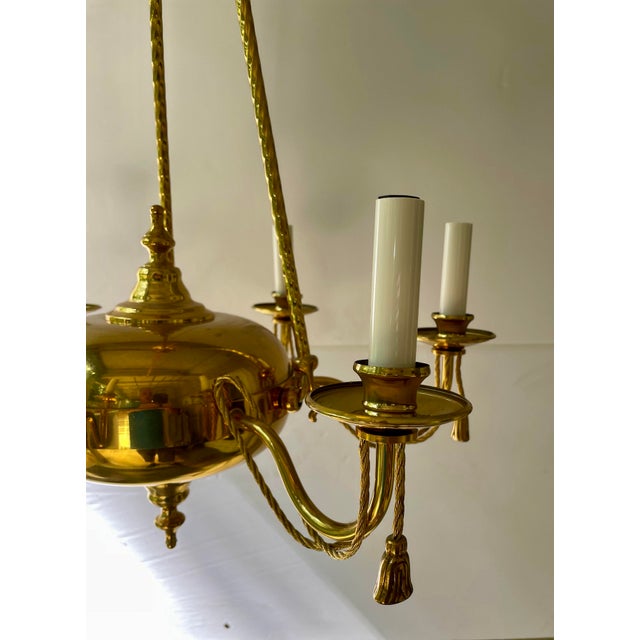 Brass Tassel Chandelier with six arms and original ceiling cap. Rewired with new off white candle covers. Good overall...