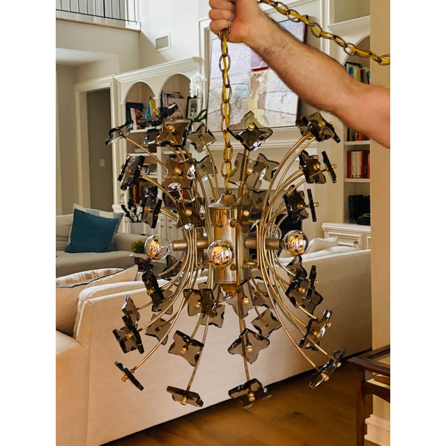 A spectacular Italian Mid-Century Modern sputnik chandelier dating to the 1970s, composed of 60 slender radiating stems...