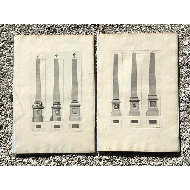 This sophisticated set of two vintage engravings celebrates the grandiosity of Neoclassical architecture, focusing on the...