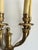 Each sconce has four lights. These are in great condition and feature a slightly floral motif at the base of each light.