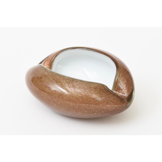 This vintage Murano style white cased and copper and gold aventurine cinched glass bowl is great for decor, serving or...