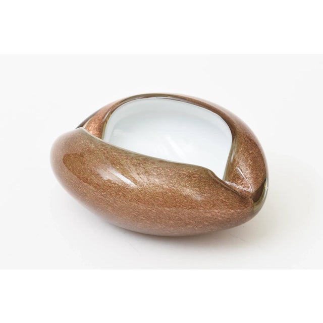 This vintage Murano style white cased and copper and gold aventurine cinched glass bowl is great for decor, serving or...