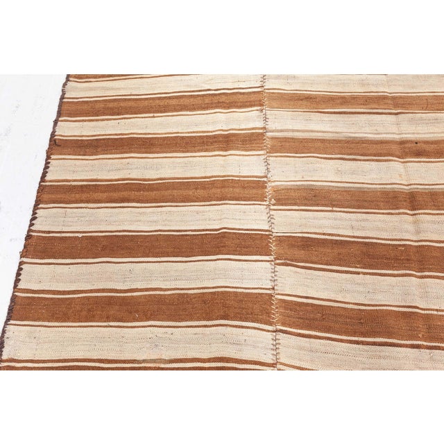 Vintage Turkish Kilim Rug Size: 6'10" × 13'2" (208 × 401 cm) This 1940s vintage Turkish Kilim rug is a striking example of...