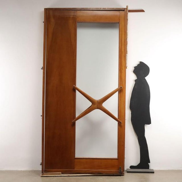 Large swing door with frame in solid beech wood and beech veneer and with glass. This piece is attributed to the mentioned...