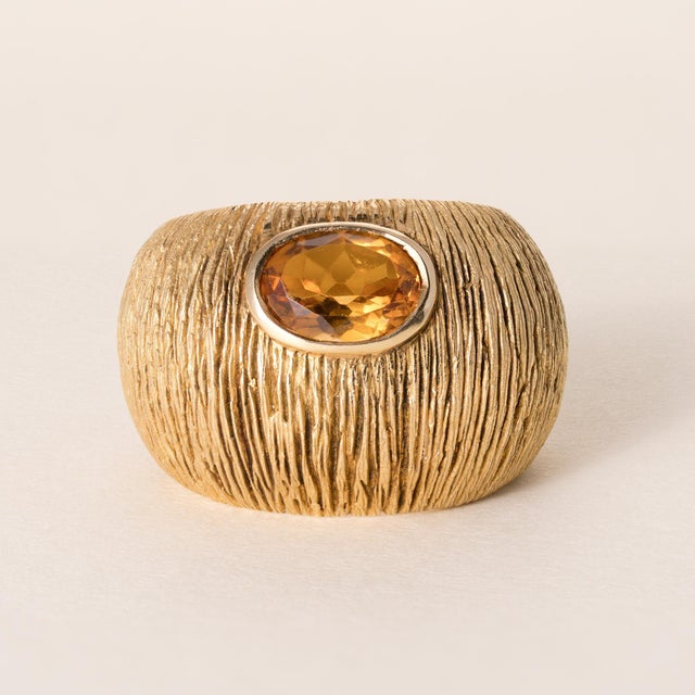 Vintage Citrine Wide Band Ring 18K Yellow Gold Circa 1990 This striking vintage ring features a vivid oval-cut citrine...
