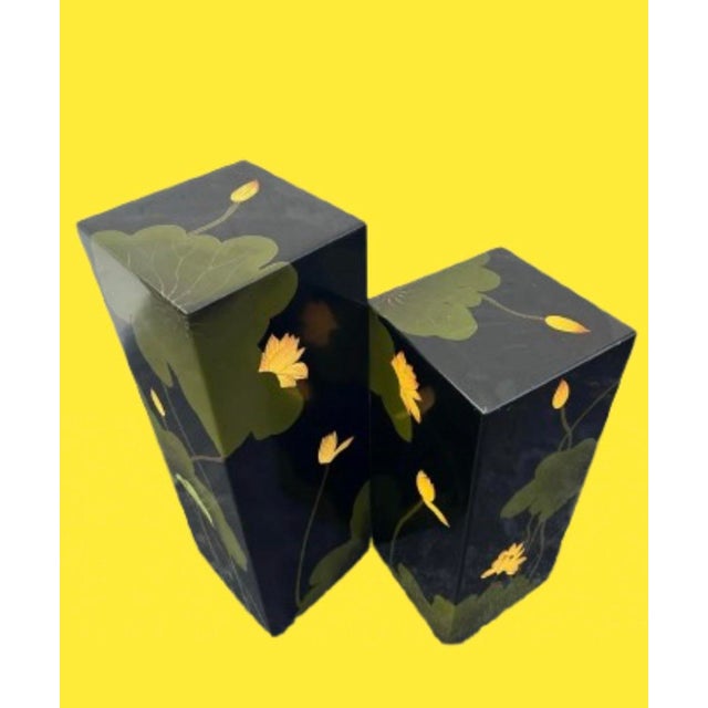 A pair of Asian lacquered pedestals with lily pad motif.Bold color palette with black, green and yellow. Circa 1970s Large...
