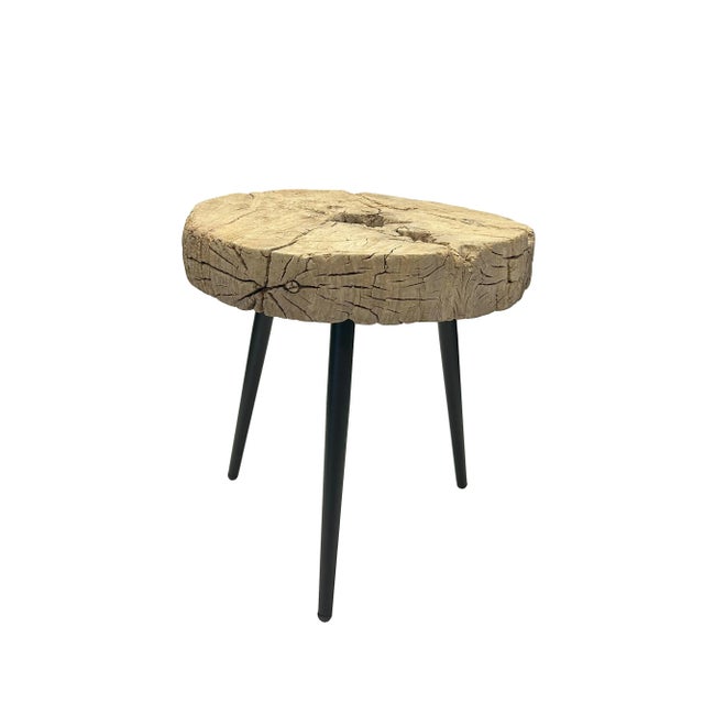 This unique vintage side table boasts a thick, round wooden top crafted from an old wheel, giving it a rustic and...