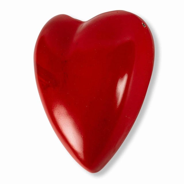 Small heart-shaped vase made by Terra company in Teplice. It is made of porcelain and painted with red glaze. It can be...