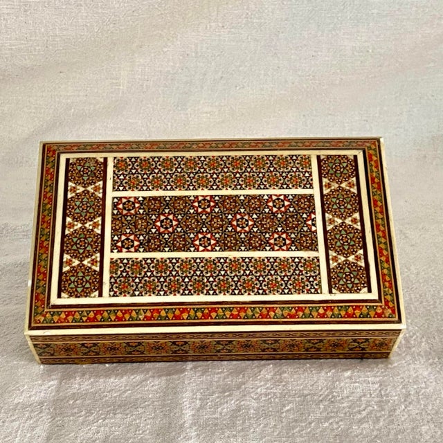 Starting with a beach wood box the intricate mosaic patterns on the surface is created using bone mother of pearl and dyed...
