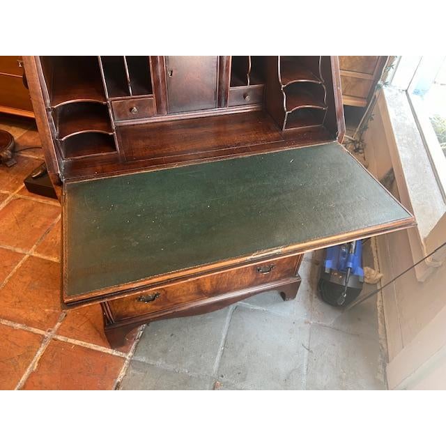 Early 20th Century George II Style Walnut Slant Front Secretary/Bookcase, the mirrored doors with etched crowns, open to a...