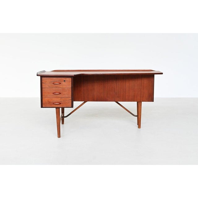 This striking boomerang-shaped writing desk was designed by peter løvig nielsen and produced by løvig in denmark circa...