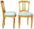 Two French Louis XVI side accent chairs featuring ornate carvings with turned and fluted accents and needlepoint seat....