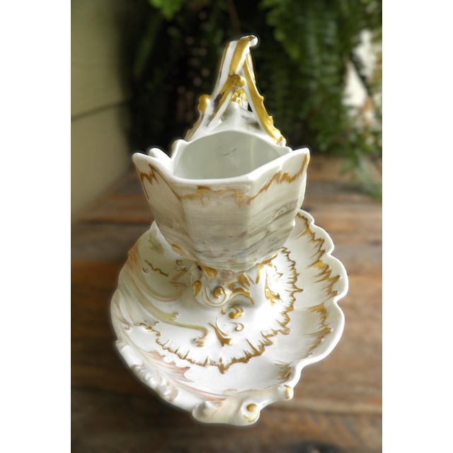 The William Guerin Limoges France gravy/sauce boat is made of ivory porcelain, oval-shaped and features a gilt bordered...