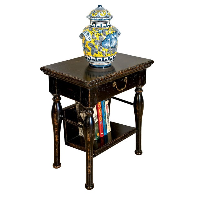 Hand crafted in Italy from solid walnut, this small end table features an antique black finish with warm brown undertones...