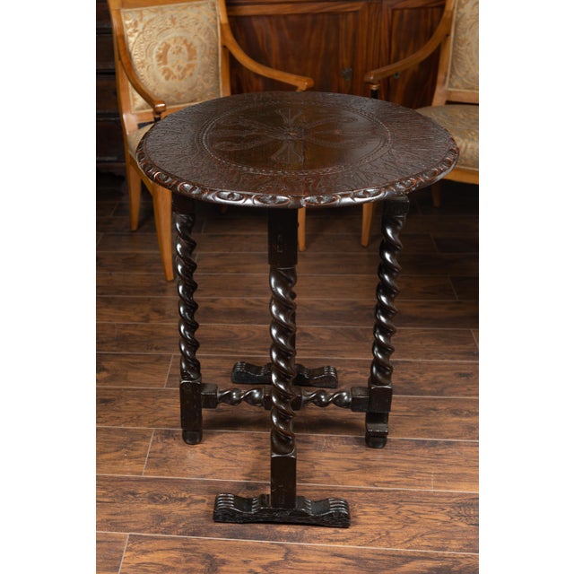 An English oak gate leg oval table from the mid-19th century, with carved top and barley-twist base. Born in England...
