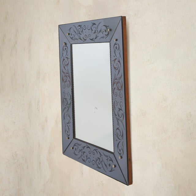 An Italian Venetian wall mirror from the 1960s, rich in detail and quietly luminous. The frame is composed of hand-cut,...
