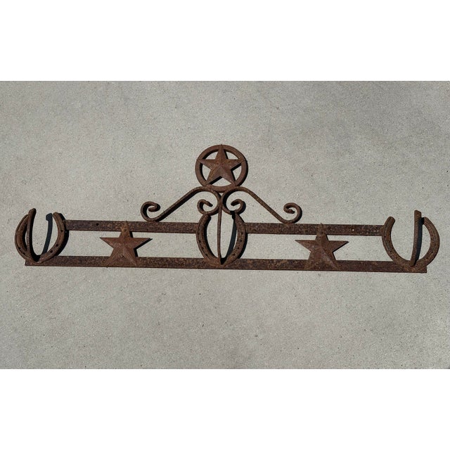 Vintage rustic iron western 3-hook rack with horseshoes and stars. Beautiful rusty patina from years of exposure. From the...