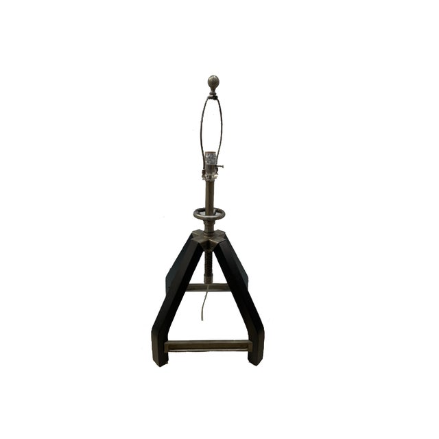 Colton table lamp with a tripod-style base in a vintage steel finish, paired with a tapered white fabric shade. Industrial...