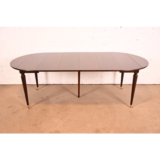A gorgeous French Regency Louis XVI style extension drop leaf dining table By Kindel Furniture USA, Circa 1960s Beautiful...