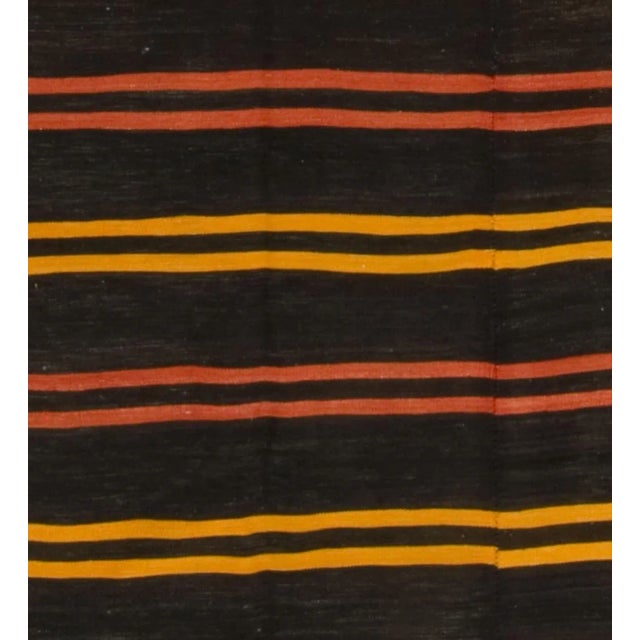 This 1950s vintage Turkish Kilim, a flat weave rug handwoven with care, showcases simplicity and boldness that lend a...