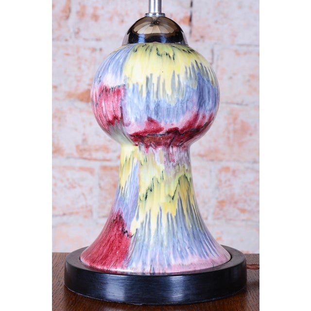 This decorative table lamp dates back to the 1960s and represents a striking example of Czechoslovak "Mid-Century"...