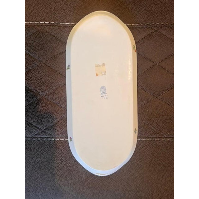 This is a classic, hand-painted porcelain sandwich tray produced by the Hungarian manufacturer Herend. It features the...
