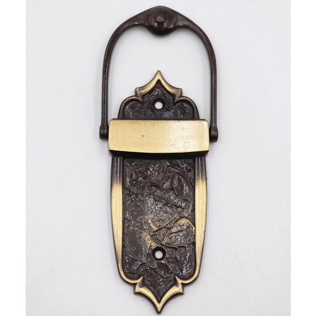 1970s Gothic style door knocker with a polished brass and black finish. Made by Amerock as part of The Monterey...