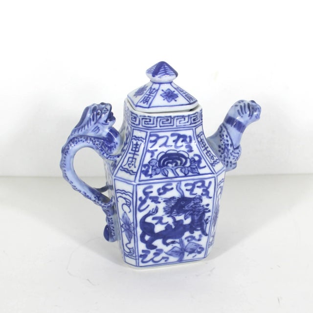 Vintage small Chinese Qianlong Nian Zhi porcelain teapot, featuring a blue and white Dragon handle and motif on the side...