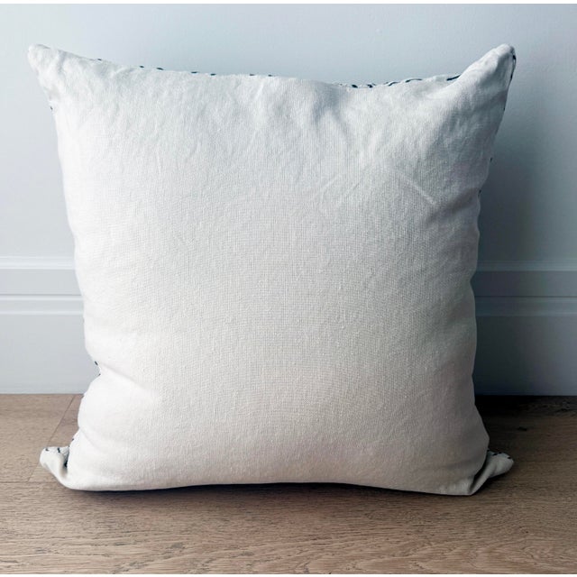 Large cotton pillow with black graphic design on front. Plain backing. Size: 24" sq Insert: Down feather pillow insert...