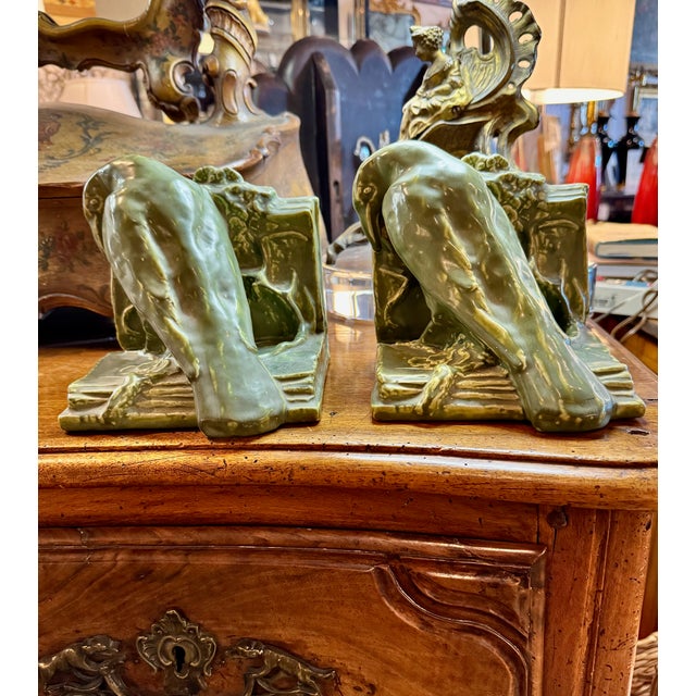 This is an iconic pair of Rookwood Pottery Bookends. The classic Rookwood crow (also known as a rook or raven) bookends...
