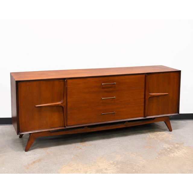 A beautifully coordinated vintage mid-century modern bedroom set featuring a long lowboy dresser, matching chest of...
