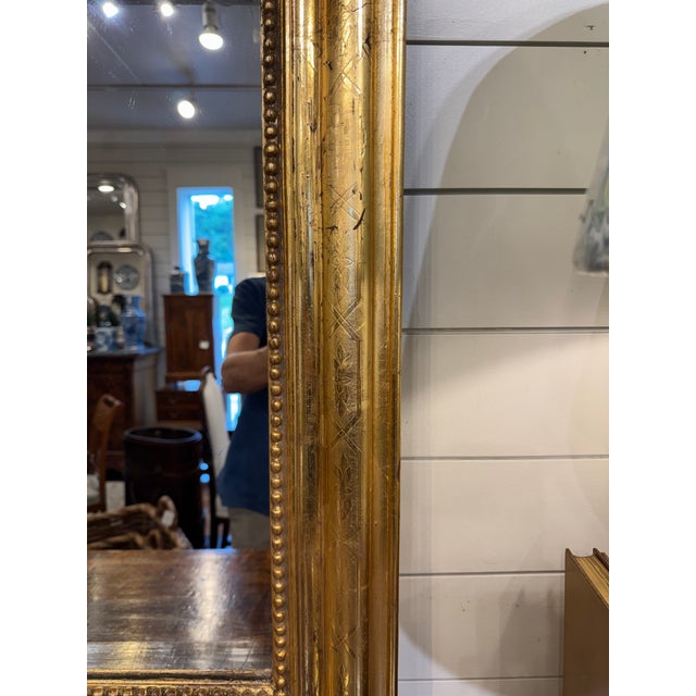This is a gorgeous 19th Century Louis Philippe mirror! The mirror features a molded design with a hand carved pattern on...
