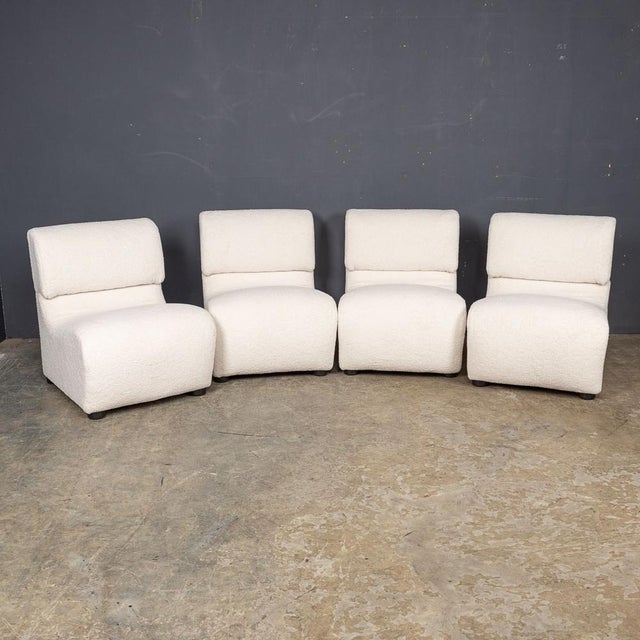 A set of four late-20th Century Italian seats, exquisitely reupholstered in lavish cream boucle fabric, offering a perfect...